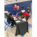 individuals writing next to a table with ballons