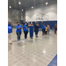 women standing in line holding their hands up