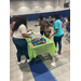 a group of woman getting snacks off of a table