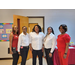 2 ladies in red outfits and 3 ladies in white shirts smiling 