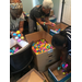 three women sorting easter eggs into boxes