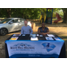 two people smiling behind a rock hill housing authority table