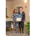 A woman with black-rimmed glasses stands with another woman who is holding open a certificate. 