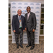 Two gentlemen stand together in front of a Rock Hill Housing Authority backdrop. 