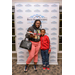 A woman and her son pause for a photo in front of the Rock Hill Housing Authority backdrop. 