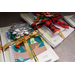 Notebooks and plastic wrapped notebook paper are wrapped with colorful ribbons and bows. 