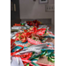 Notebooks wrapped with colorful ribbons and bows line a table. 