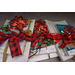 Multiple stacks of notebooks and plastic wrapped notebook paper are wrapped with colorful ribbons and bows. 