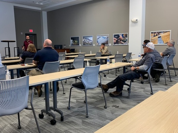 Maintenance workers listening to presentation.