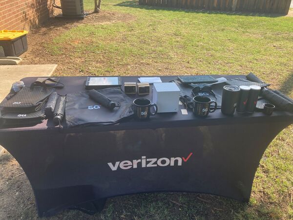 Verizon table with products on it outside. 
