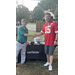 Two men are shaking hands in front of the Verizon table. 