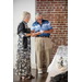  Man and woman talking and looking at a card. 