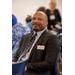  Man sitting and smiling wearing a suit.  