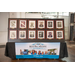  A table with the framed photos of former leaders and a Rock Hill Housing Authority banner.  