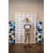  A young man standing with a framed certificate smiling broadly.  