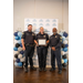  Three officers holding a framed certificate while smiling for a photo.  