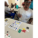  People seated at tables with Bingo cards. 