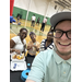  A man taking a selfie with two woman and a young girl in the background. 