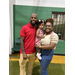  A woman and man hold a little girl and smile for a picture. 