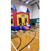  Two people watching kids bounce in the bounce house. 